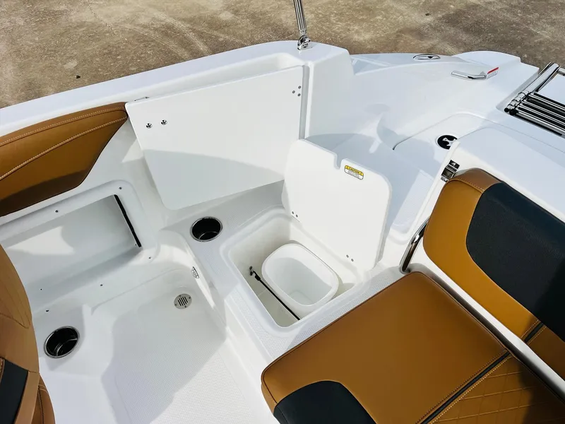Slide: The Image of 2025 Tahoe 2150 boat interior with brown seating and storage compartments. - 33