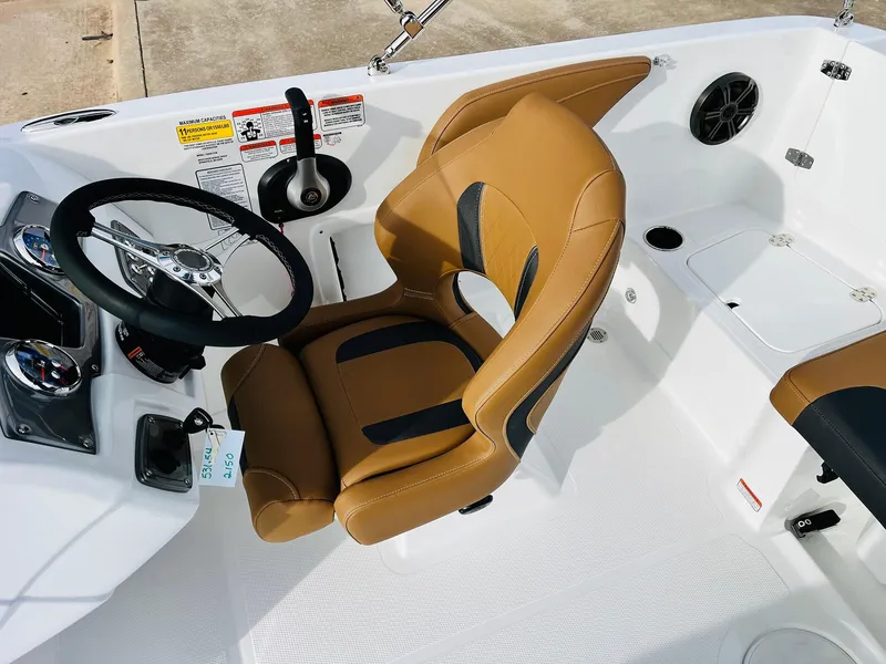 Slide: The Image of 2025 Tahoe 2150 boat interior with tan seating and steering wheel. - 36