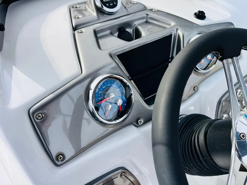 Slide: The Image of 2025 Tahoe 2150 boat dashboard with steering wheel and gauges. - 39