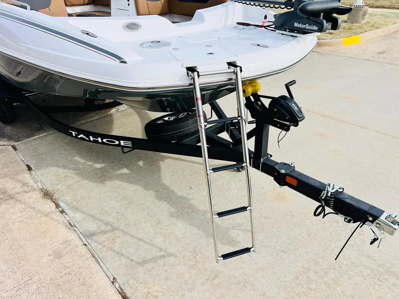 Slide: The Image of 2025 Tahoe 2150 boat on trailer with ladder and MotorGuide motor. - 4