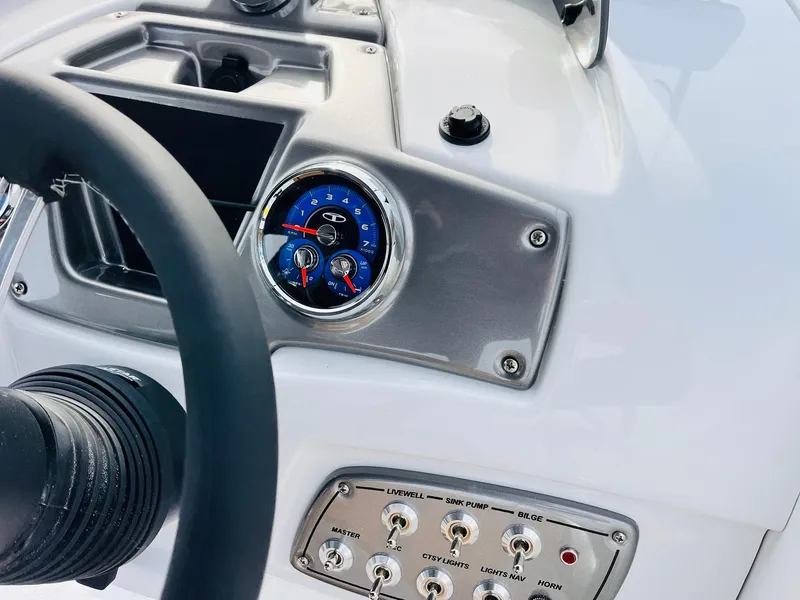 Slide: The Image of Dashboard of 2025 Tahoe 2150 boat with steering wheel and control panel. - 40