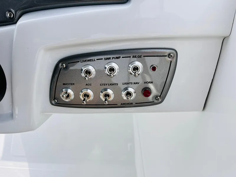 Slide: The Image of Control panel of 2025 Tahoe 2150 boat with switches for various functions. - 41