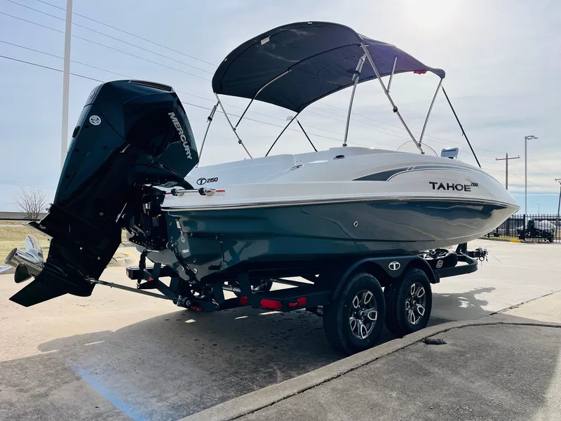 Slide: The Image of 2025 Tahoe 2150 boat on trailer with canopy and outboard motor. - 6
