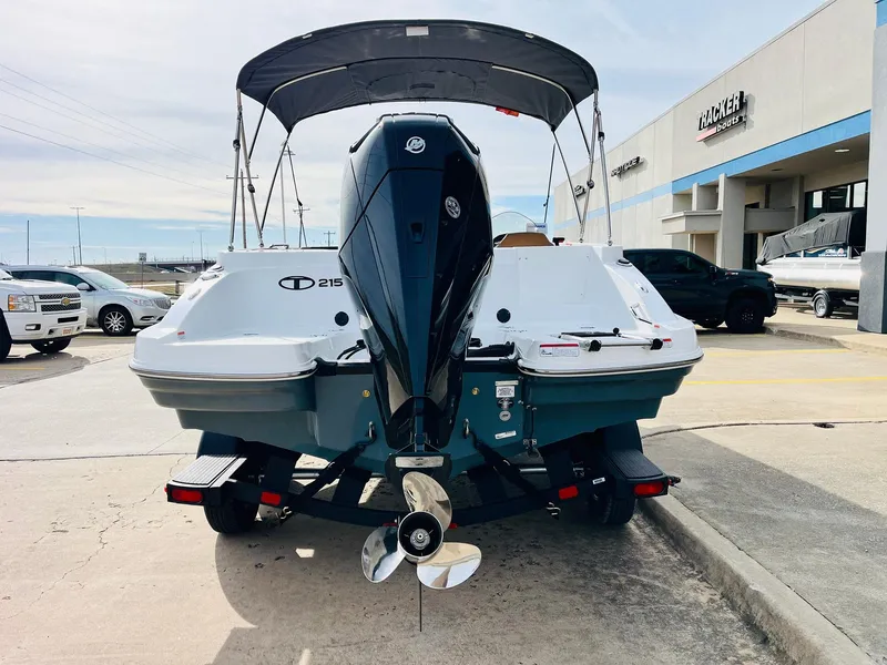 Slide: The Image of 2025 Tahoe 2150 boat with outboard motor on trailer at dealership. - 7