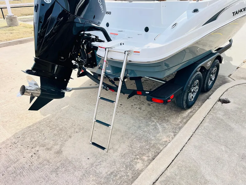 Slide: The Image of 2025 Tahoe 2150 boat with outboard motor and ladder on trailer. - 9