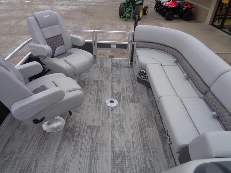Slide: The Image of 2025 Ranger Reata 220FC boat interior with gray seating and wood-patterned flooring. - 10
