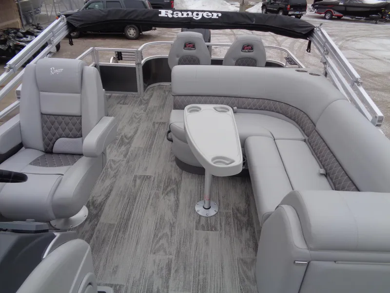 Slide: The Image of 2025 Ranger Reata 220FC pontoon boat with luxurious gray seating and modern design. - 11