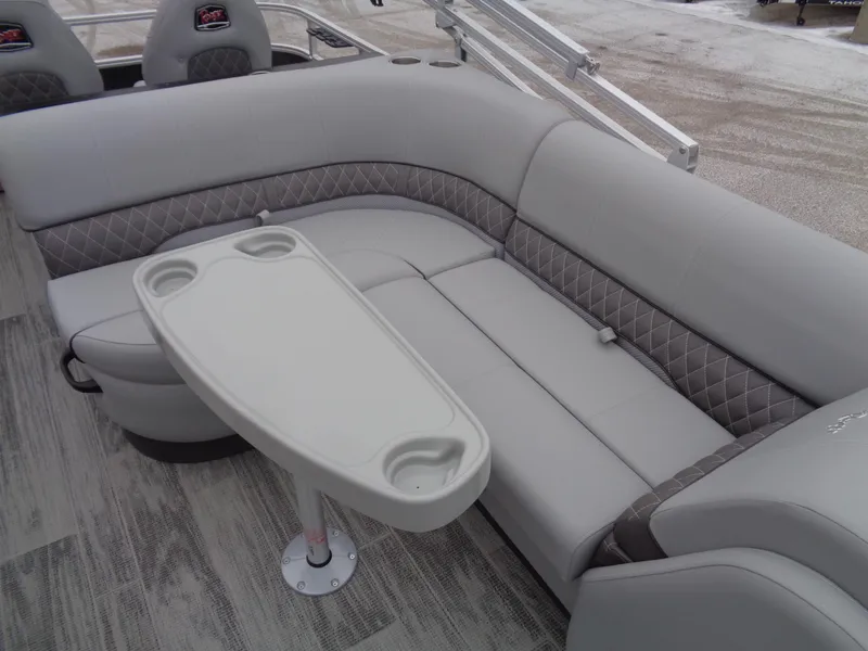 Slide: The Image of 2025 Ranger Reata 220FC boat interior with gray seating and a white table. - 12