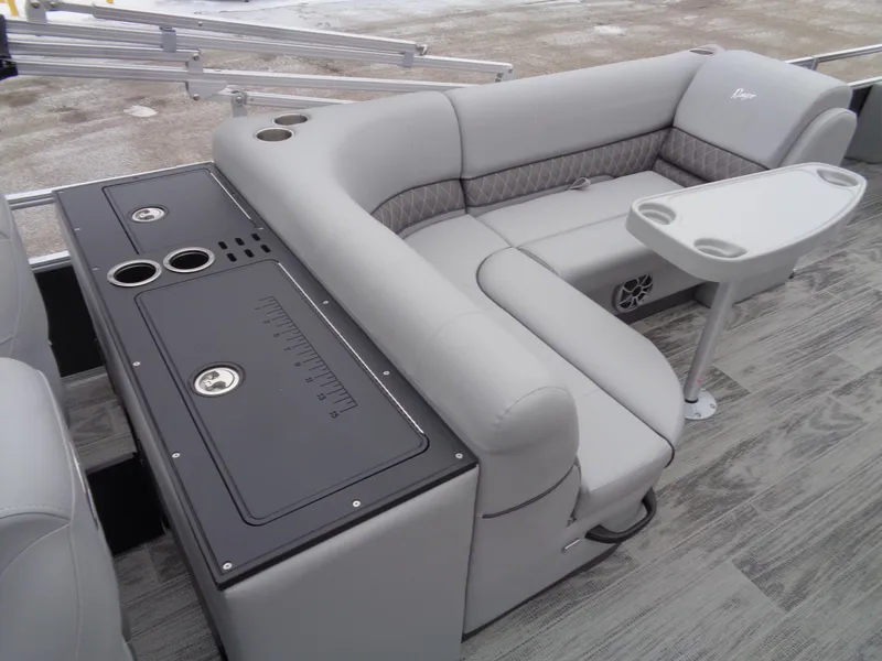 Slide: The Image of 2025 Ranger Reata 220FC boat interior with gray seating and table. - 15