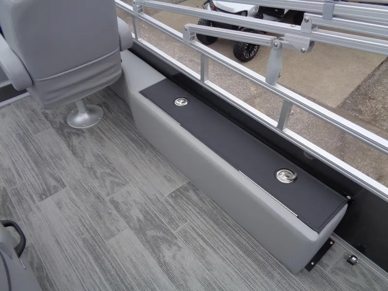 Slide: The Image of 2025 Ranger Reata 220FC boat interior with gray seating and flooring. - 16