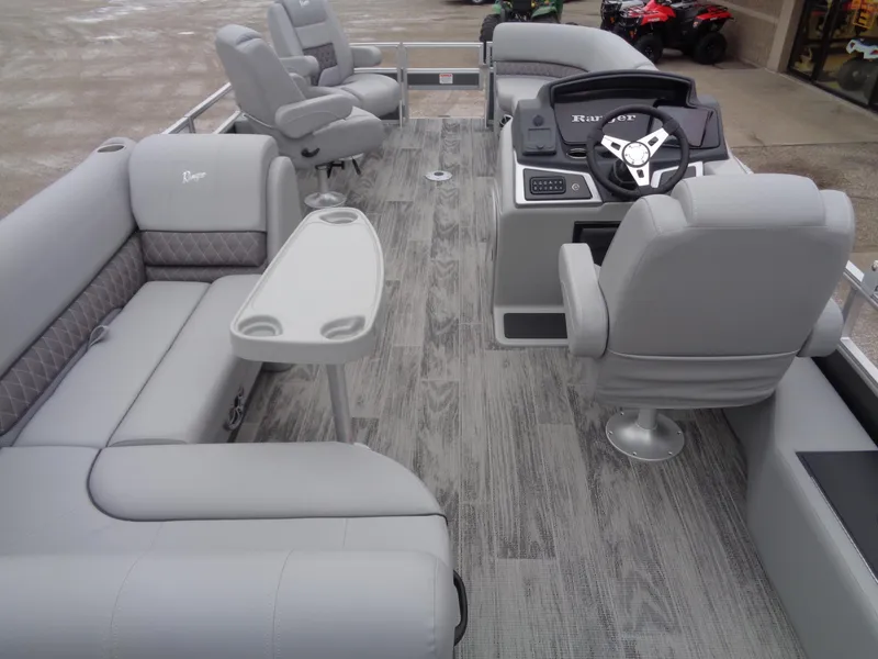 Slide: The Image of 2025 Ranger Reata 220FC pontoon boat interior with gray seating and modern helm. - 17