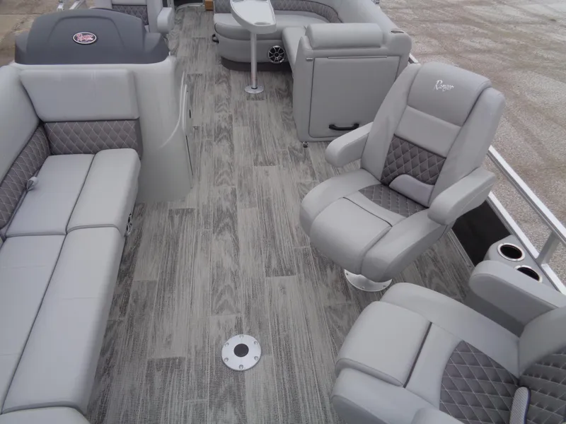 Slide: The Image of 2025 Ranger Reata 220FC boat interior with gray seating and wood-style flooring. - 6