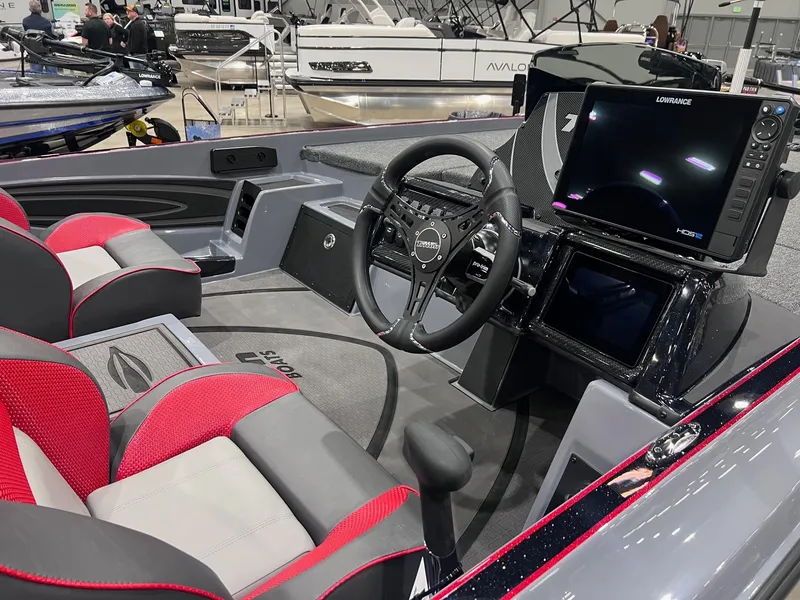 Slide: The Image of 2025 Triton 21XP Patriot boat interior with modern steering and navigation system. - 2