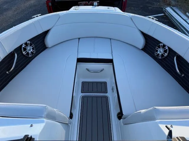 Slide: The Image of 2025 Sea Ray SPX 230 boat interior with white seating and sleek design. - 2