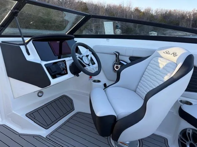 Slide: The Image of 2025 Sea Ray SPX 230 boat interior with modern helm and comfortable seating. - 5