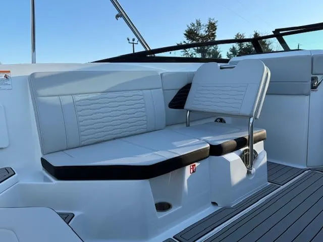 Slide: The Image of 2025 Sea Ray SPX 230 boat interior with white seating and sleek design. - 9