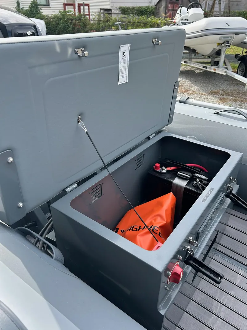 Slide: The Image of 2023 Highfield Classic 340 GT boat storage compartment with open lid and equipment inside. - 15