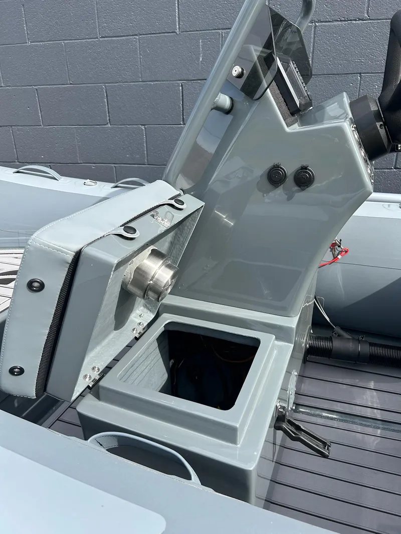 Slide: The Image of 2023 Highfield Classic 340 GT boat console with storage compartment open. - 18