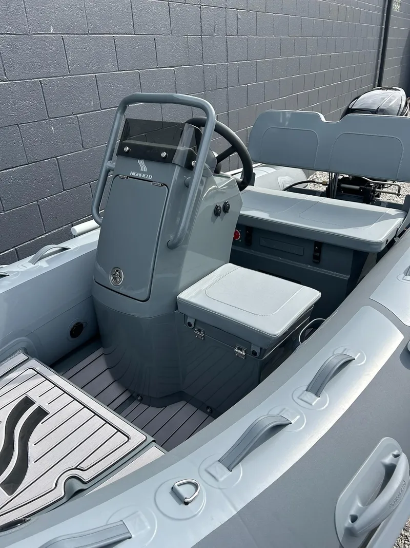 Slide: The Image of 2023 Highfield Classic 340 GT boat interior with steering console and seating. - 19