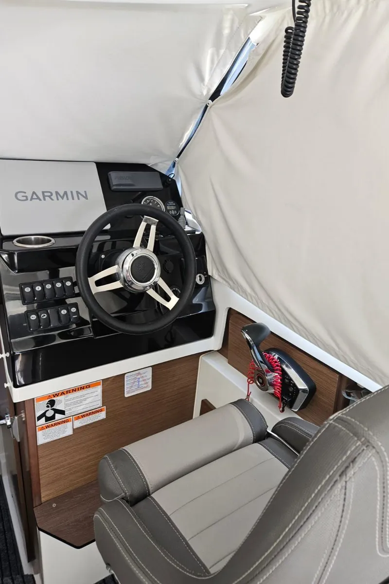 Slide: The Image of 2023 Jeanneau NC795 helm with Garmin navigation system and comfortable seating. - 26