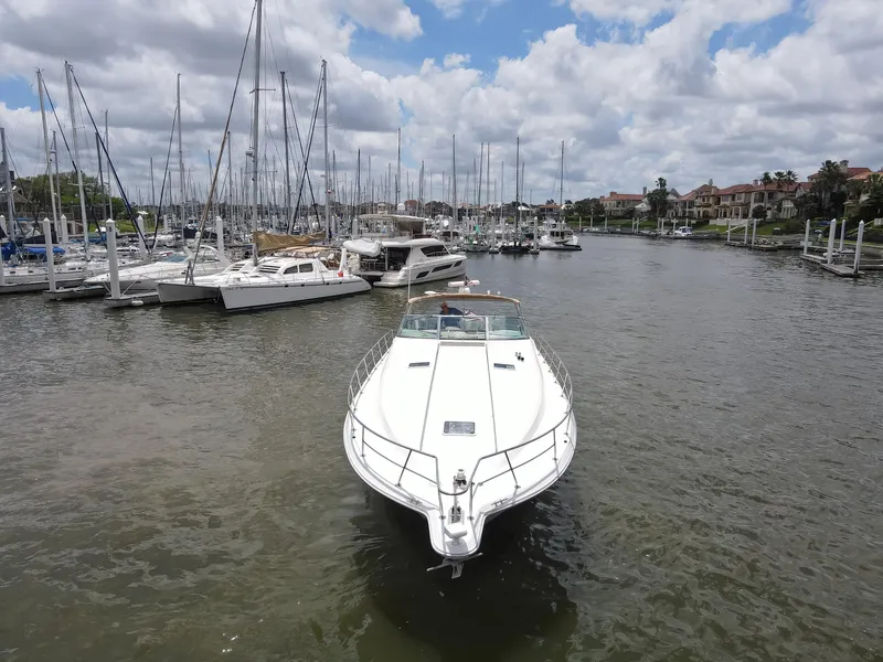 Slide: The Image of 1996 Sea Ray 500 Sundancer yacht docked in a marina with sailboats. - 14