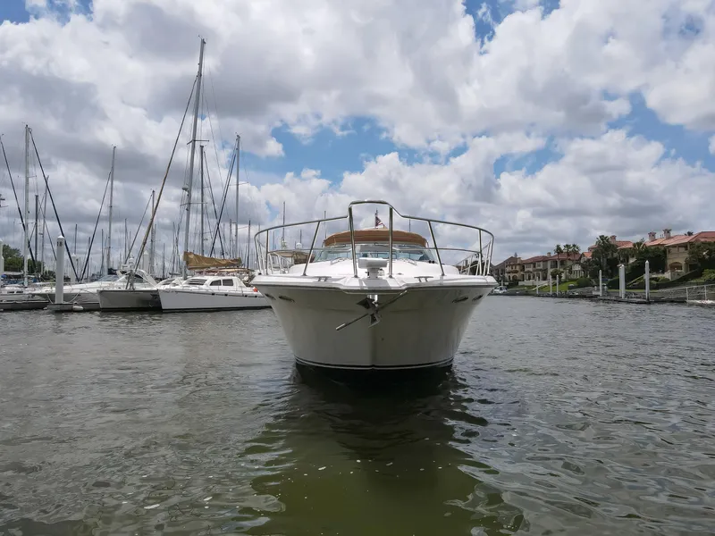 Slide: The Image of 1996 Sea Ray 500 Sundancer yacht docked in a marina under cloudy skies. - 16