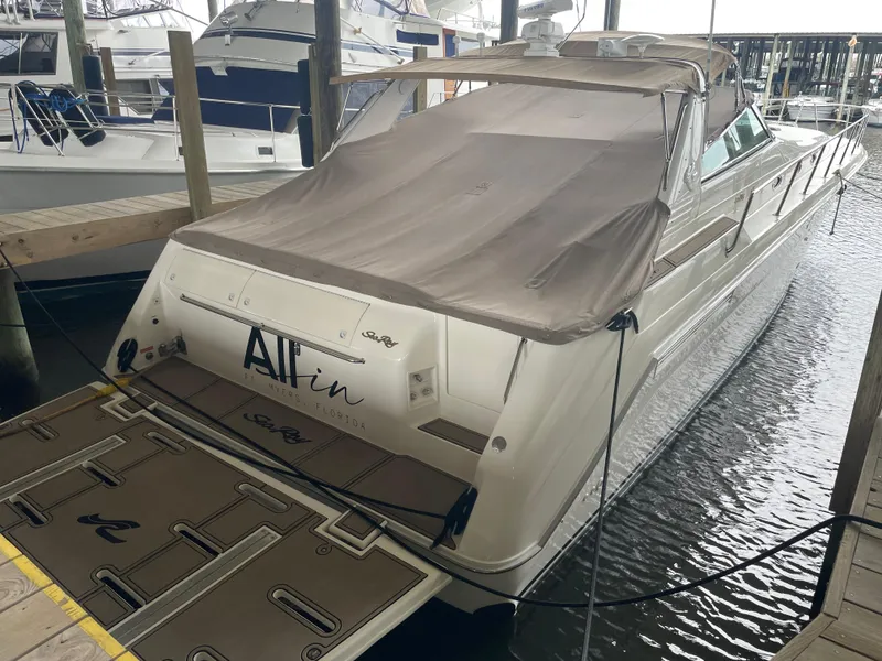 Slide: The Image of 1996 Sea Ray 500 Sundancer docked, covered, rear view in marina setting. - 20