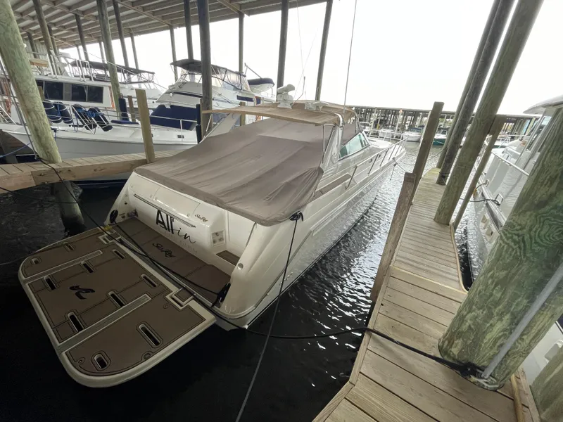 Slide: The Image of 1996 Sea Ray 500 Sundancer docked in a marina under a covered shelter. - 22