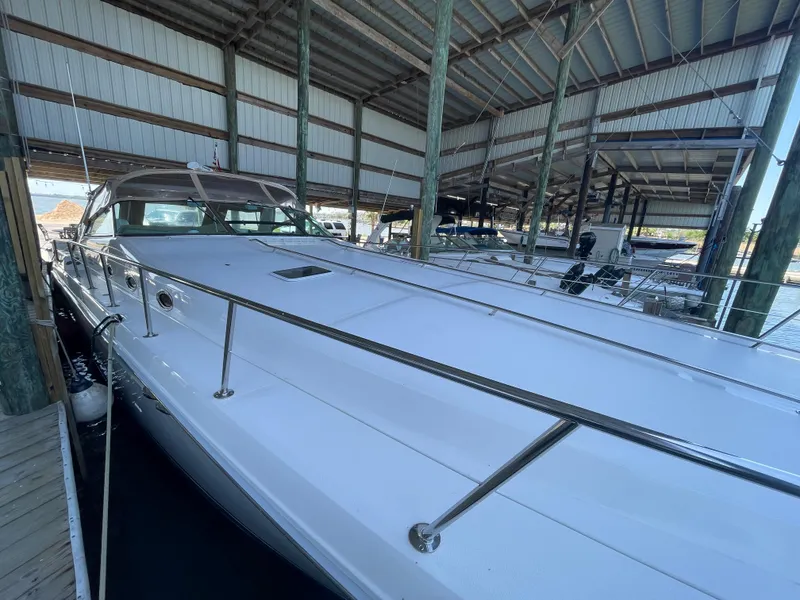 Slide: The Image of 1996 Sea Ray 500 Sundancer yacht docked in a covered marina. - 23