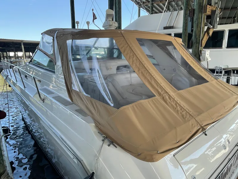 Slide: The Image of 1996 Sea Ray 500 Sundancer yacht with tan canopy docked in marina. - 24