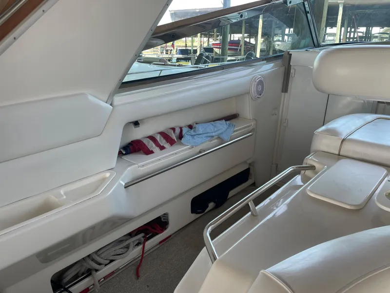 Slide: The Image of Interior of 1996 Sea Ray 500 Sundancer yacht with white seating and storage compartments. - 27