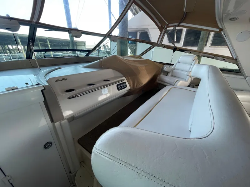Slide: The Image of Interior of 1996 Sea Ray 500 Sundancer yacht with white seating and helm. - 29