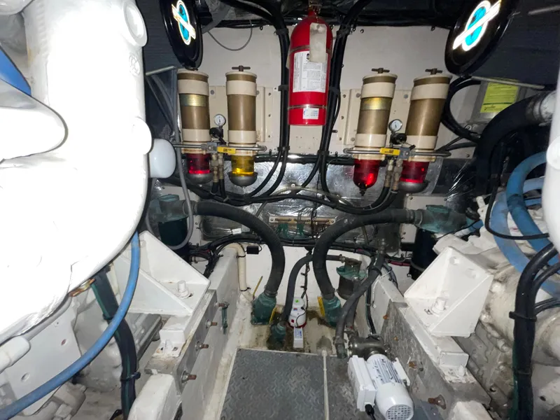 Slide: The Image of Engine room of 1996 Sea Ray 500 Sundancer with filters and fire extinguisher. - 35