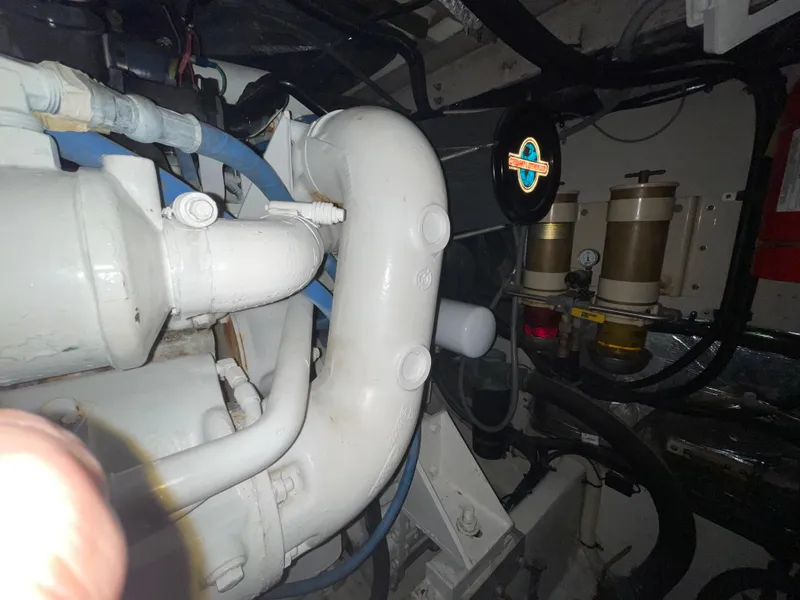 Slide: The Image of Engine room of 1996 Sea Ray 500 Sundancer with visible pipes and components. - 37