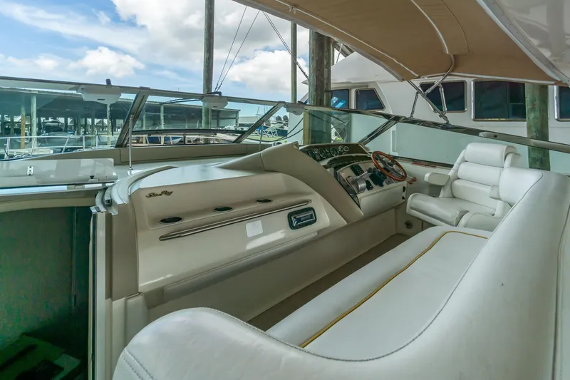 Slide: The Image of Interior view of 1996 Sea Ray 500 Sundancer yacht with white seating and control panel. - 41