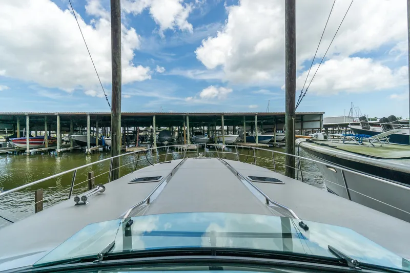Slide: The Image of 1996 Sea Ray 500 Sundancer yacht docked at marina under blue sky. - 43
