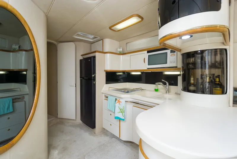 Slide: The Image of Interior of 1996 Sea Ray 500 Sundancer yacht, featuring modern kitchen amenities. - 48