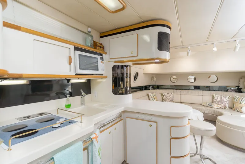 Slide: The Image of Luxurious 1996 Sea Ray 500 Sundancer yacht interior with modern kitchen and seating area. - 49