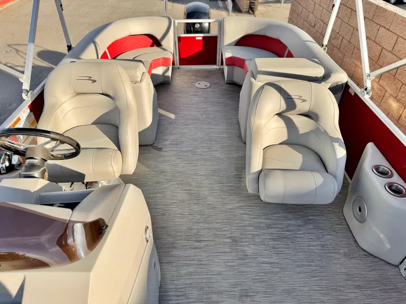 Slide: The Image of 2021 Bennington 23 LS RSD pontoon boat interior with beige and red seating. - 13