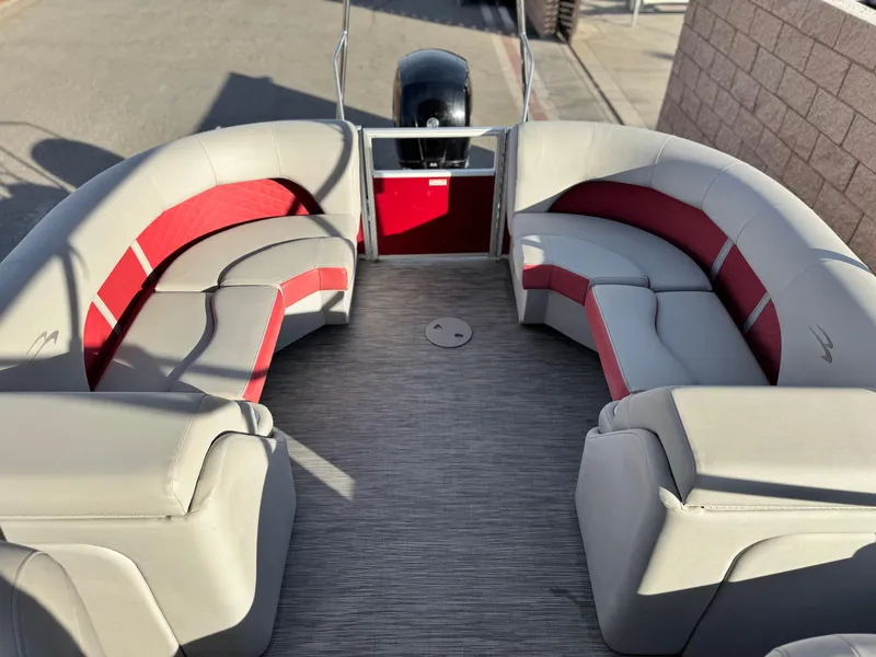 Slide: The Image of 2021 Bennington 23 LS RSD pontoon boat with red and gray seating. - 15