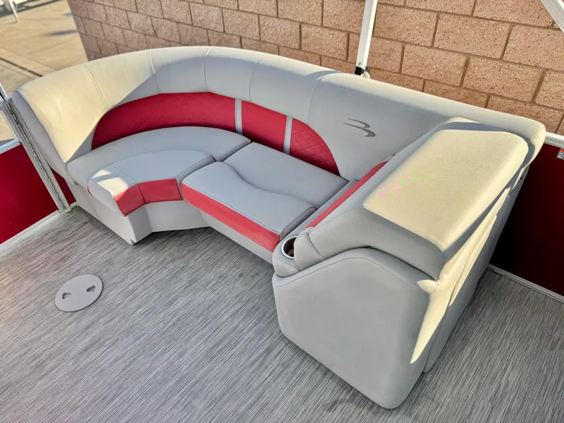 Slide: The Image of 2021 Bennington 23 LS RSD boat seating with red and gray upholstery. - 16