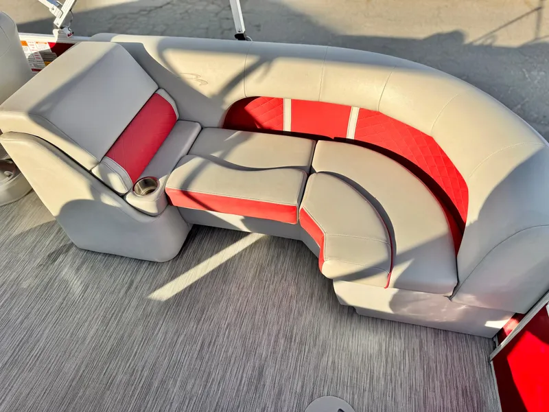 Slide: The Image of 2021 Bennington 23 LS RSD boat interior with red and gray seating. - 17