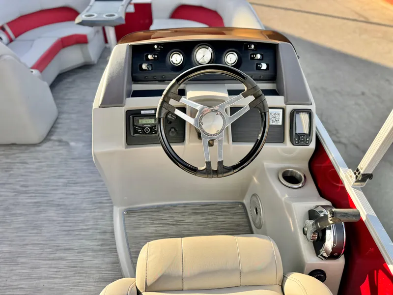 Slide: The Image of 2021 Bennington 23 LS RSD boat dashboard with steering wheel and controls. - 21