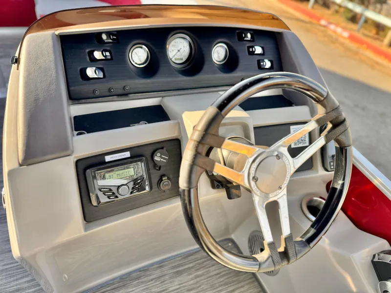 Slide: The Image of 2021 Bennington 23 LS RSD boat dashboard with steering wheel and control panel. - 22