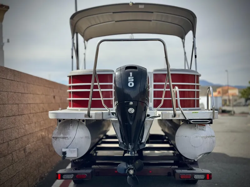 Slide: The Image of 2021 Bennington 23 LS RSD pontoon boat with 150 HP engine, rear view. - 5
