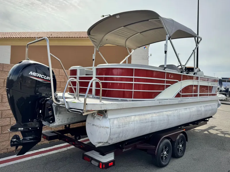 Slide: The Image of 2021 Bennington 23 LS RSD pontoon boat with Mercury outboard engine on trailer. - 6