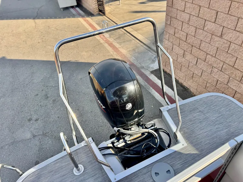Slide: The Image of 2021 Bennington 23 LS RSD boat with Mercury outboard motor, docked on pavement. - 8