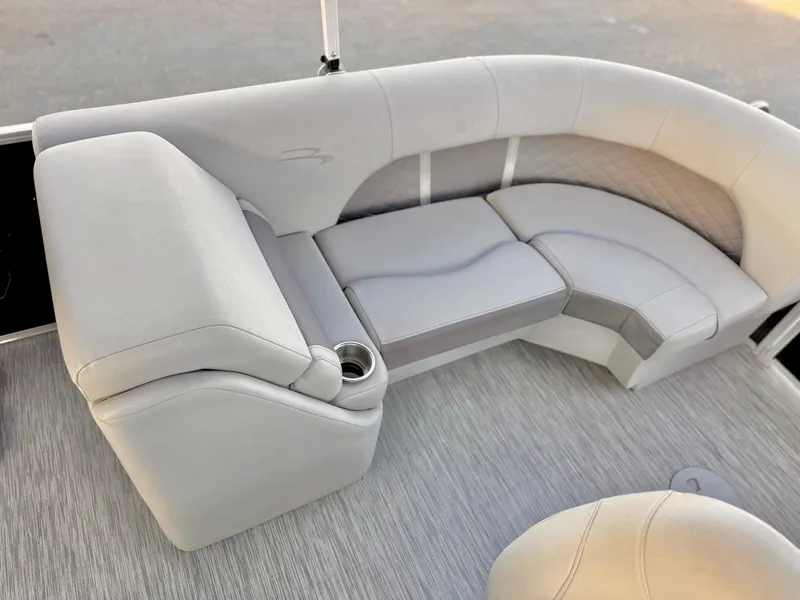 Slide: The Image of 2021 Bennington 23 LPD boat interior with plush seating and cup holder. - 17