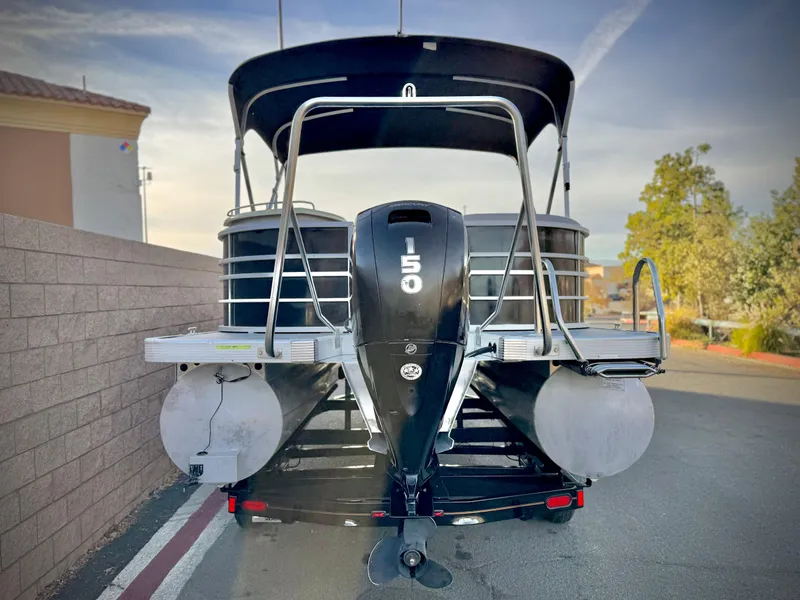 Slide: The Image of 2021 Bennington 23 LPD pontoon boat with 150 HP engine, parked outdoors. - 5