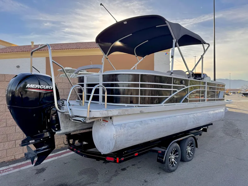Slide: The Image of 2021 Bennington 23 LPD pontoon boat with Mercury outboard engine on trailer. - 6